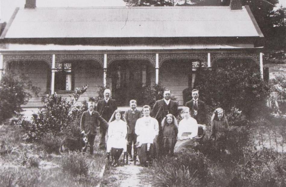 n early photo of the Brown family outside their cottage on Lower Shotover Rd.  The man second...