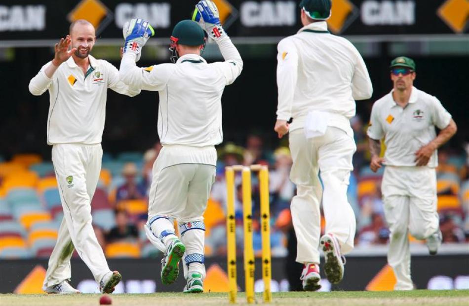 Nathan Lyon celebrates taking a wicket with Peter Nevil. Photo: Reuters