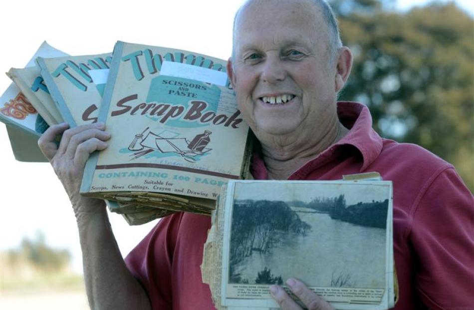 Neil Gamble  holds some Taieri History from old Otago Daily Times newspaper clippings collected...