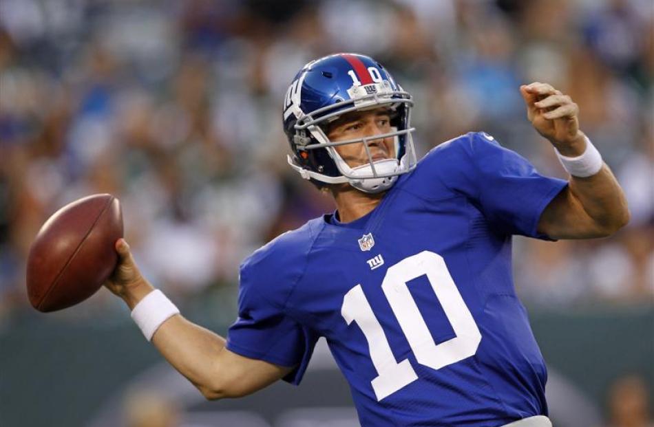 New York Giants quarterback Eli Manning passes against the New York Jets during the first quarter...