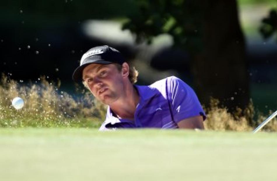 New Zealand amateur Joshua Munn chips out of a bunker during round one of the New Zealand Open at...