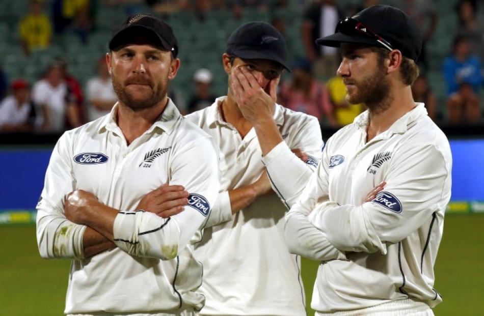 New Zealand captain Brendon McCullum (L) stands with teammates B-J Watling (C) and Kane...