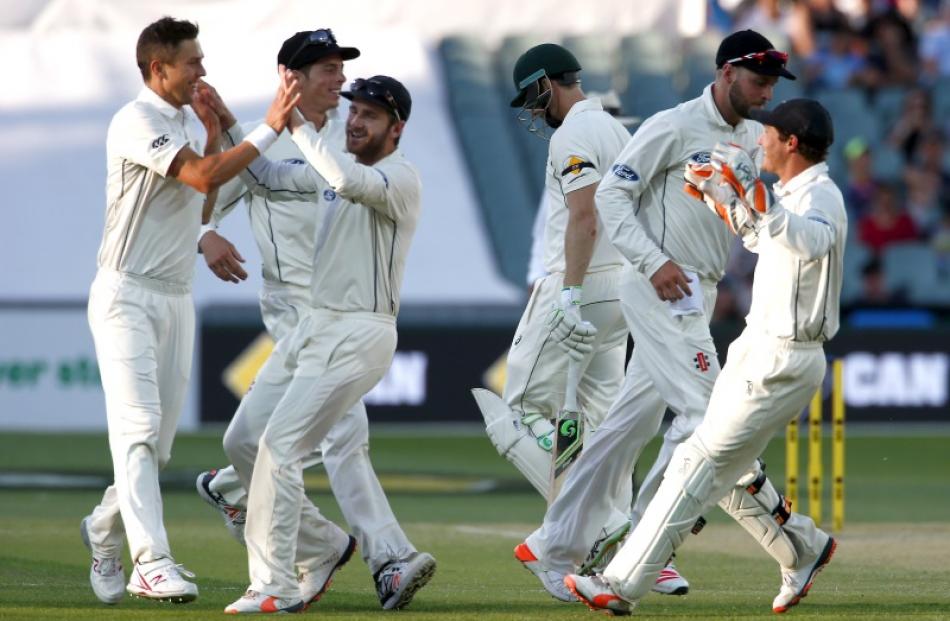 New Zealand players celebrate after picking up the wicket of Adam Voges in the last session of...