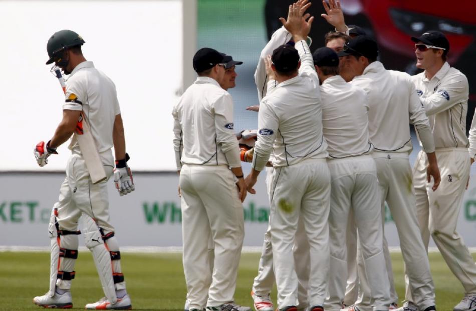 New Zealand players celebrate taking the wicket of Mitchell Marsh. Photo: Reuters