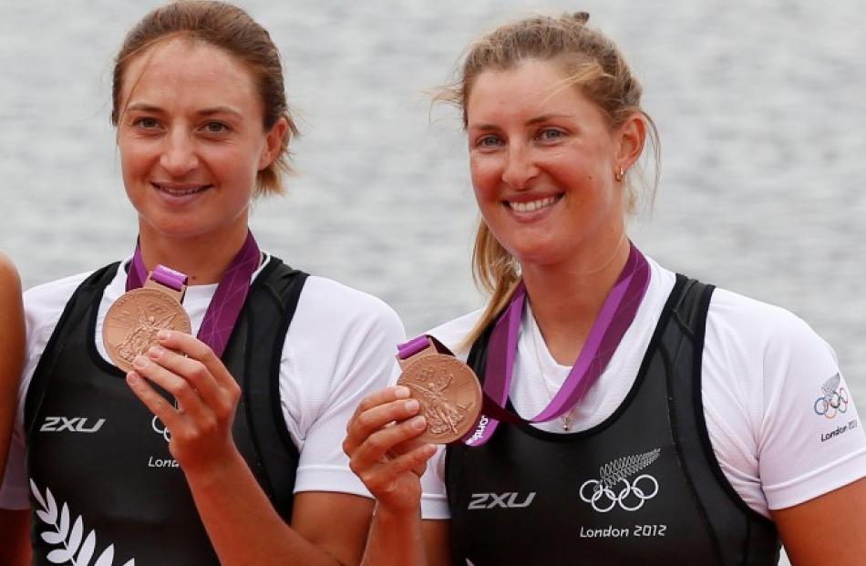 New Zealand's bronze medallists Juliette Haigh (L) and Rebecca Scown stand during the victory...