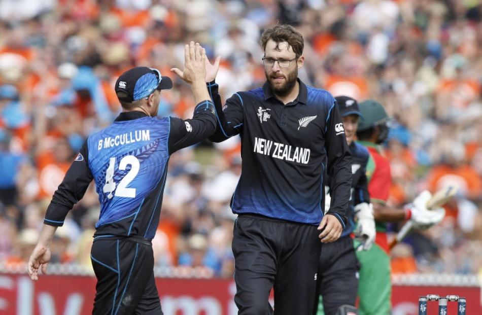 New Zealand's Daniel Vettori (R) celebrates dismissing Bangladesh's Soumya Sarkar with Brendan...