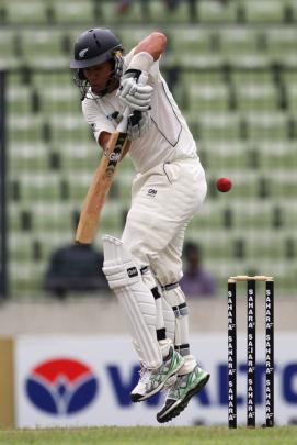 New Zealand's Ross Taylor jumps to play a ball against Bangladesh, during their second day of...