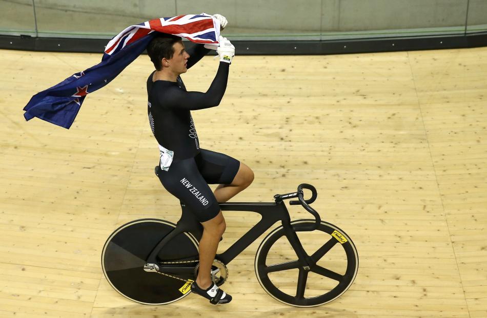 New Zealand's Sam Webster celebrates after winning the men's sprint finals cycling race at the...