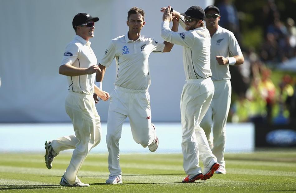 New Zealand's Trent Boult (2nd L) celebrates with teammates after taking the wicket of Australia...