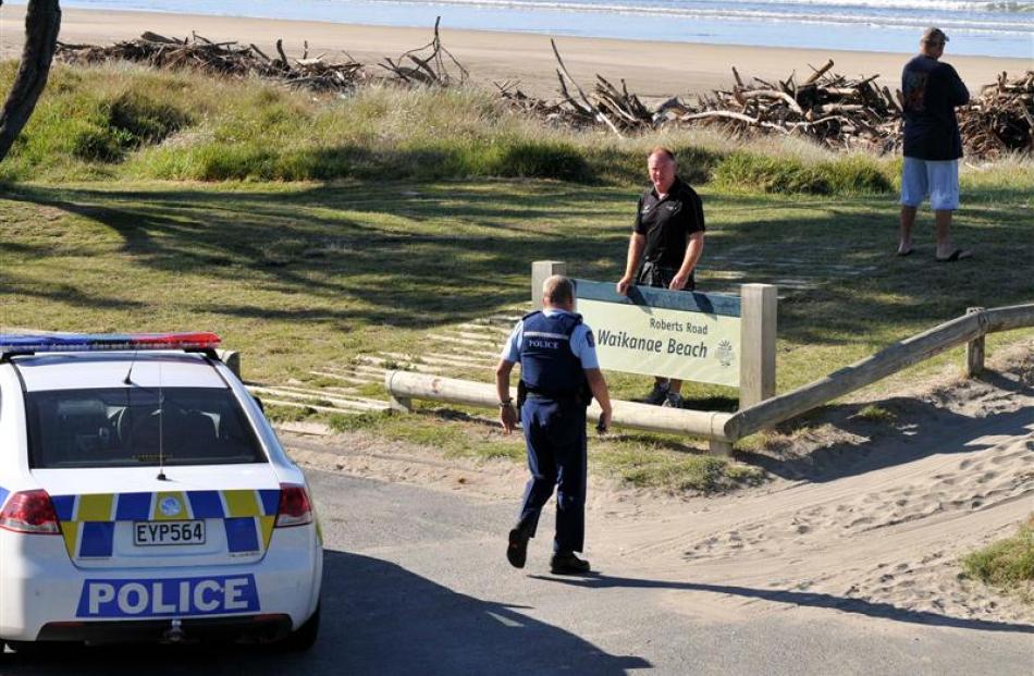 Police warn tsunami watchers at Midway Beach in Gisborne as residents along the beachfront are...