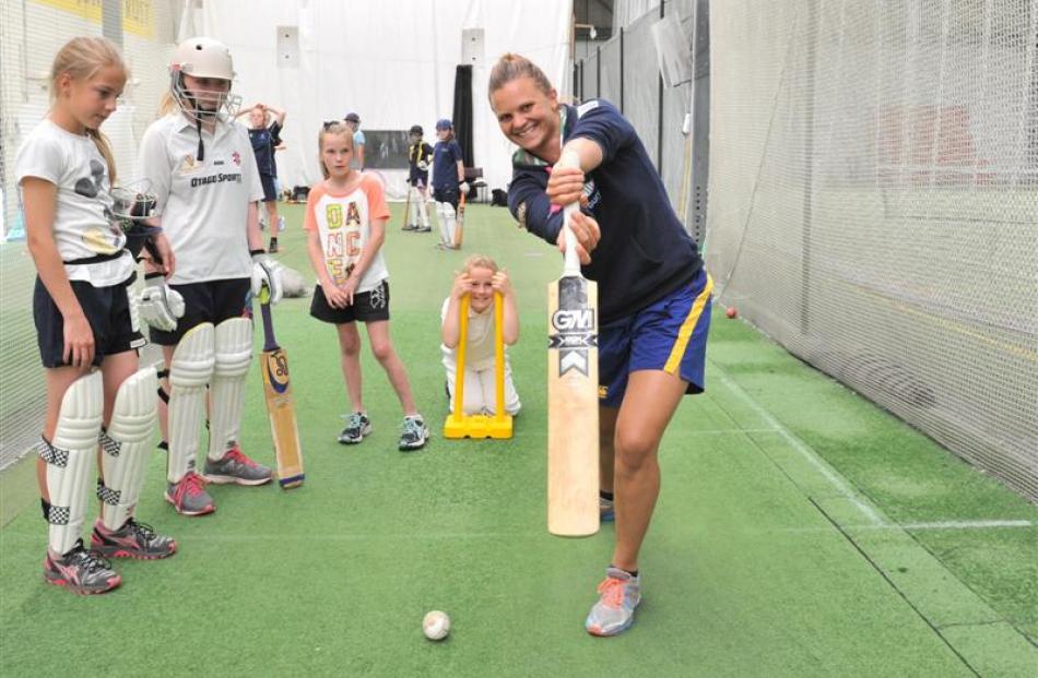 New Zealand women's cricket captain Suzie Bates displays her technique to young players at the...