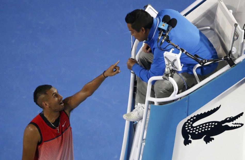 Nick Kyrgios having words with the umpire on Friday night. Photo: Reuters