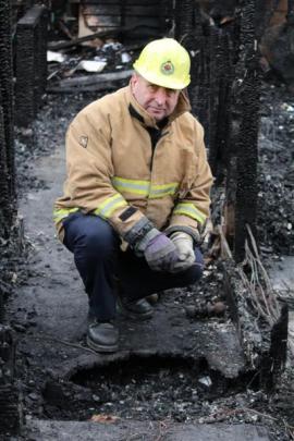 North Otago fire safety management officer Stu Ide inspects the  historic homestead destroyed by...