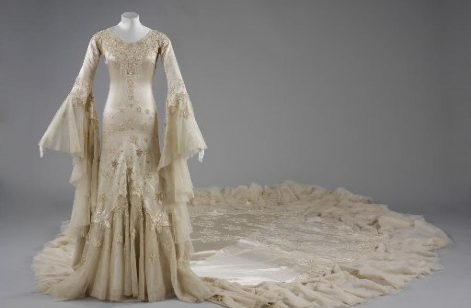 Notable British designer Norman Hartnell designed  this magnificent silk satin and tulle gown...