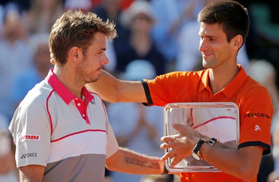 Novak Djokovic (R) congratulates Stan Wawrinka during the trophy ceremony after Wawrinka's win in...