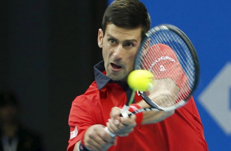 Novak Djokovic returns a shot against Zhang Ze. Photo: Reuters
