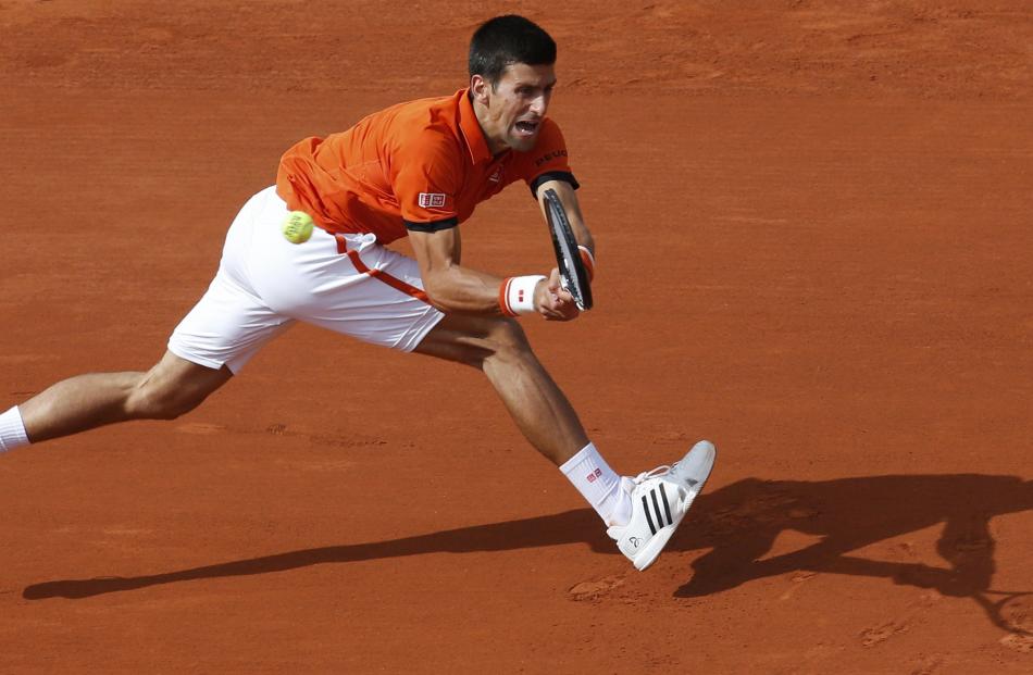 Novak Djokovic survived an injury scare and a slippery court. Photo by Reuters
