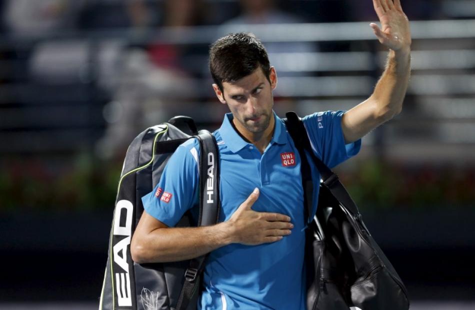 Novak Djokovic waves after withdrawing from this match against Feliciano Lopez. Photo: Reuters