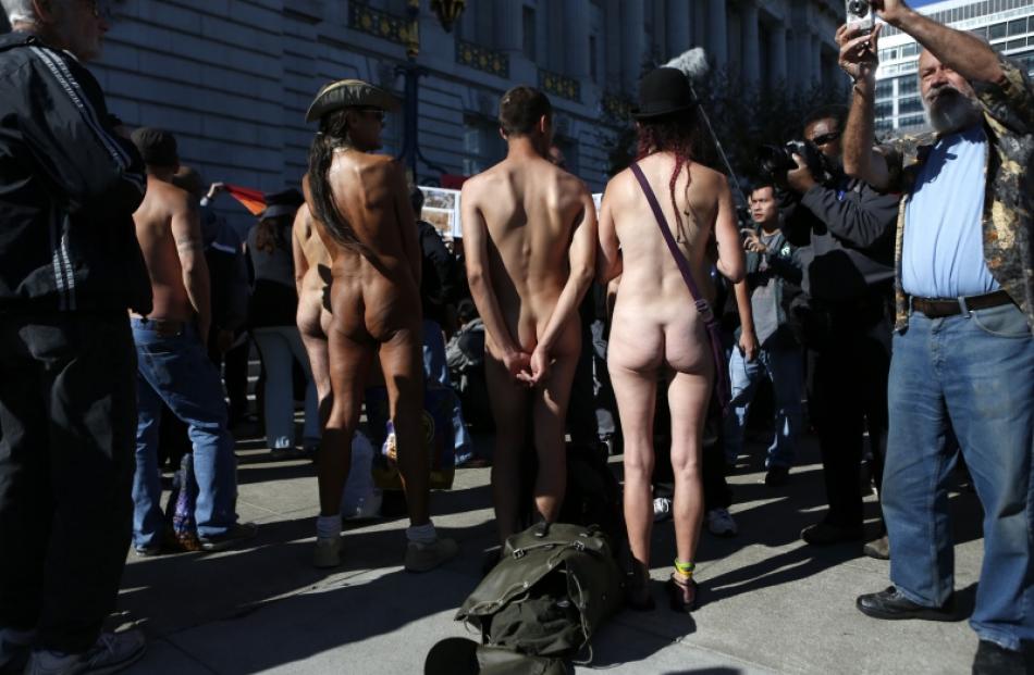 Nudists listen to speakers during a rally against the 'Wiener bill', which addresses nudity in...
