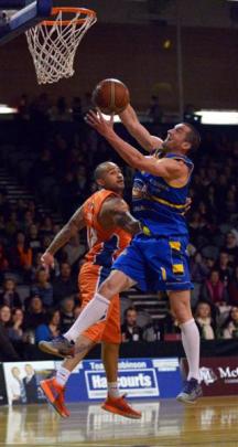 Nuggets captain Mark Dickel grabs a rebound from Kevin Braswell, of the Southland Sharks, during...