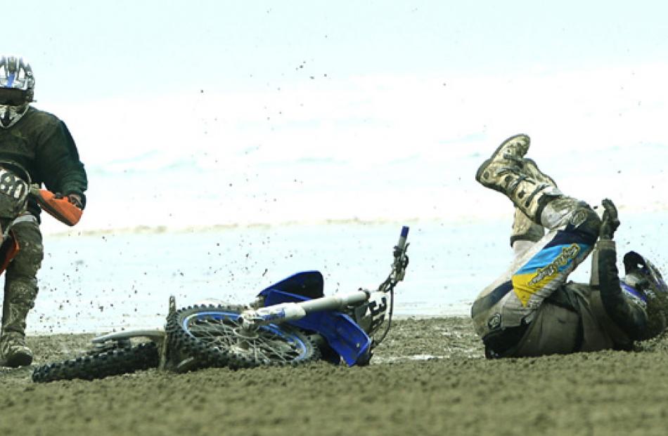 Number 380, Ryan McKenzie of Wyndham, on his Husaberg FE 570 falls off while watched by number...