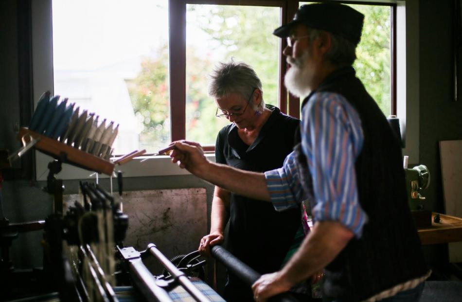 Oamaru weavers Rod and Sue McLean work on their  Hattersley loom. Photos: Rebecca Ryan