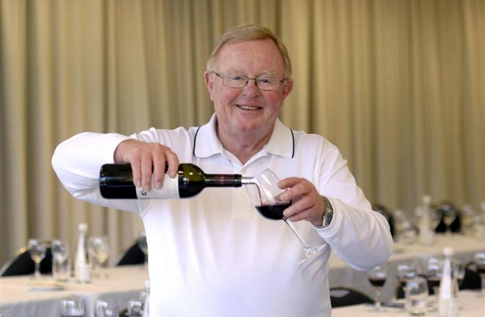 John Buck, of Te Mata Wine, pours a glass of red  before a tasting at the Dunedin Public Art...