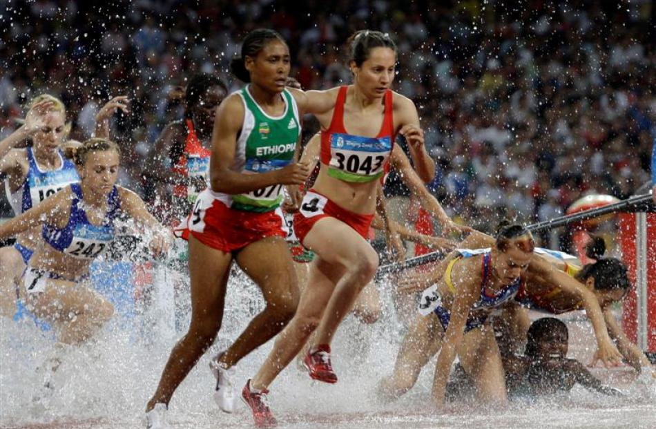 Sofia Assefa of Ethiopia, foreground left, and Asli Cakir of Turkey, foreground right, clear the...