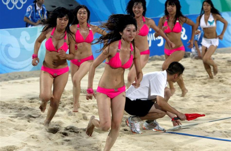 Chinese cheerleaders take part in rehearsals of matches at the Beach Volleyball venue for the...