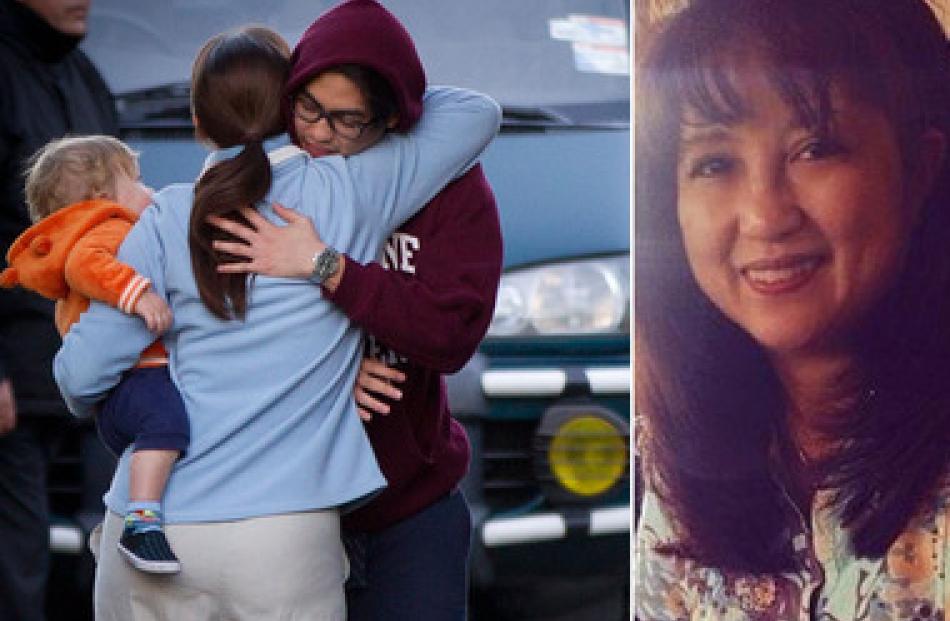 One of Blessie Gotingco's sons is comforted by a neighbour. Right, one of the last photos of...