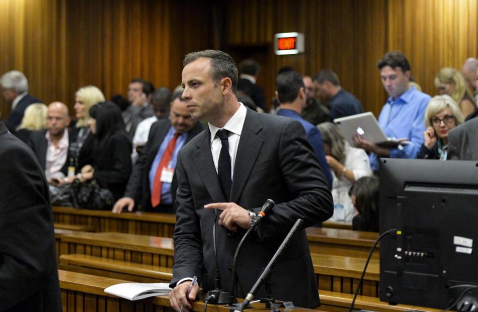 Oscar Pistorius stands in the dock during his trial for the murder of his girlfriend Reeva...