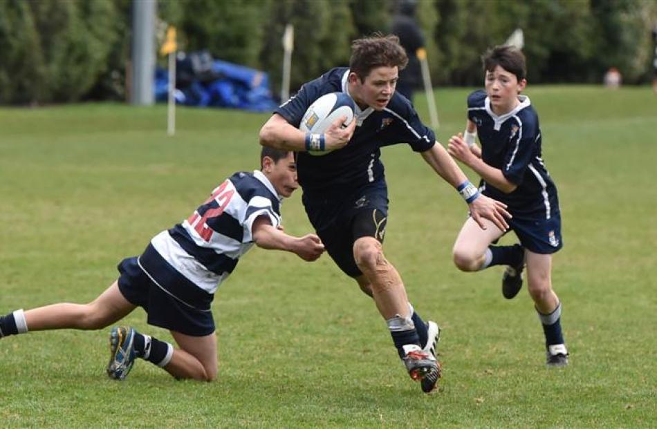 Otago Boys' High School first five eighth Tom McGregor eludes the tackle of Matthew Oldridge, of...
