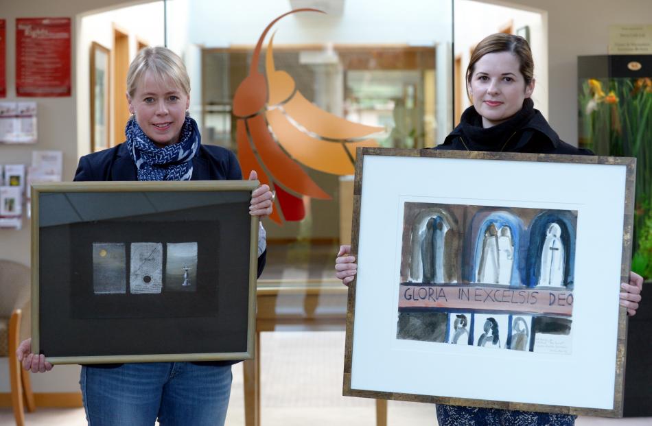Otago Community Hospice chief executive Ginny Green (left) holds Timeshift by P. Smith and...