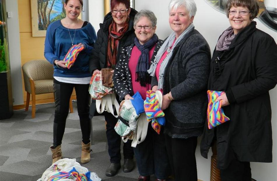 Otago Community Hospice funding co-ordinator Tessa Scott (left)  receives 250 wheat bags from...