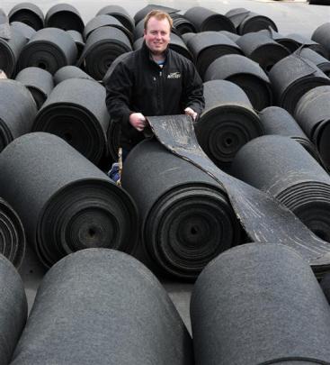 Otago Hockey Association hockey and facilities manager Sam Brown with the underlay of the...