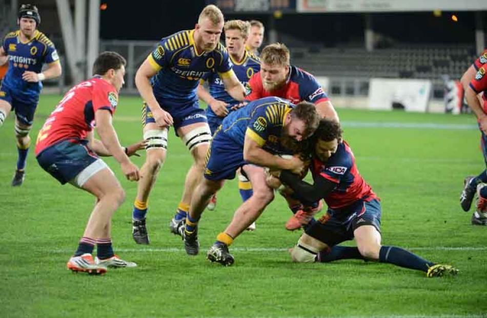 Otago hooker Liam Coltman is tackled by by Tasman first five Marty Banks. Photo Linda Robertson