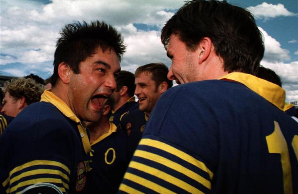 Otago loose forward Taine Randell yells with delight at team-mate John Leslie after the 1998...