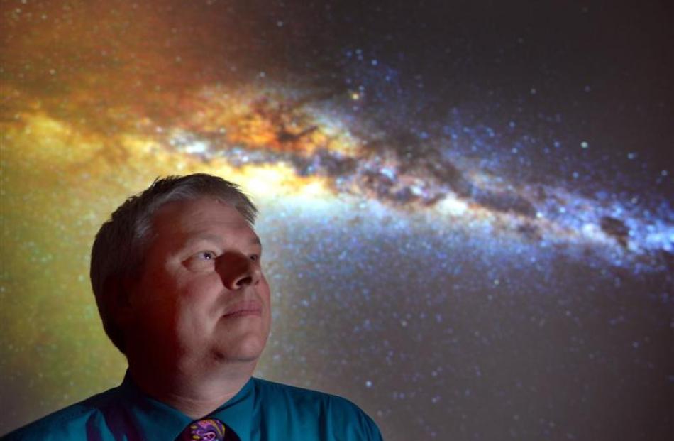 Otago Museum director Dr Ian Griffin with  a night sky image he took from the Otago Peninsula...