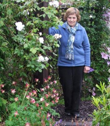 Otago Rose Society secretary Marilyn Langford in her Dunedin garden. She is standing by a...