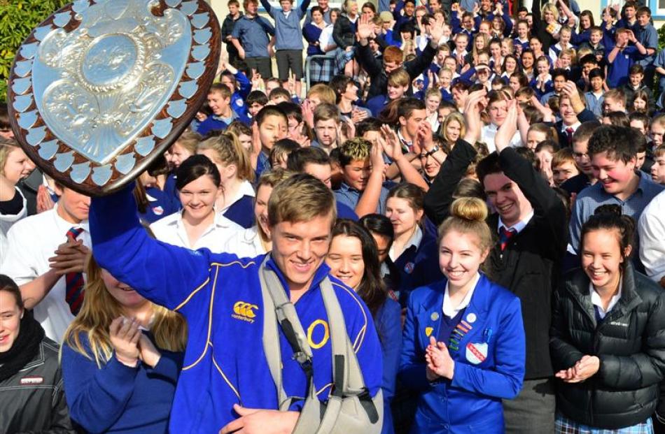 Otago rugby player Tony Ensor shows off the shield at South Otago High School in Balclutha...