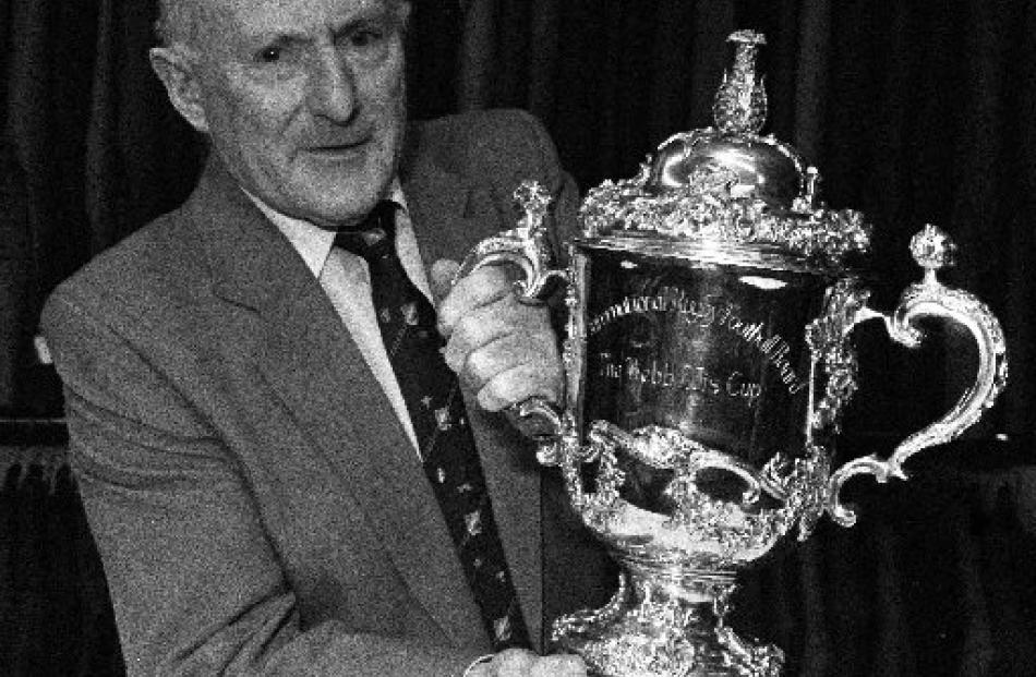 Otago rugby stalwart Charlie Saxton with the William Webb Ellis Trophy.