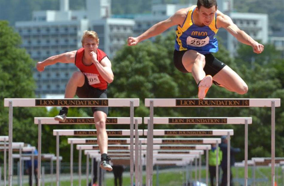 Otago's Felix McDonald (16) shows Christiaan Smit a clean pair of heels to win the 100m hurdles...