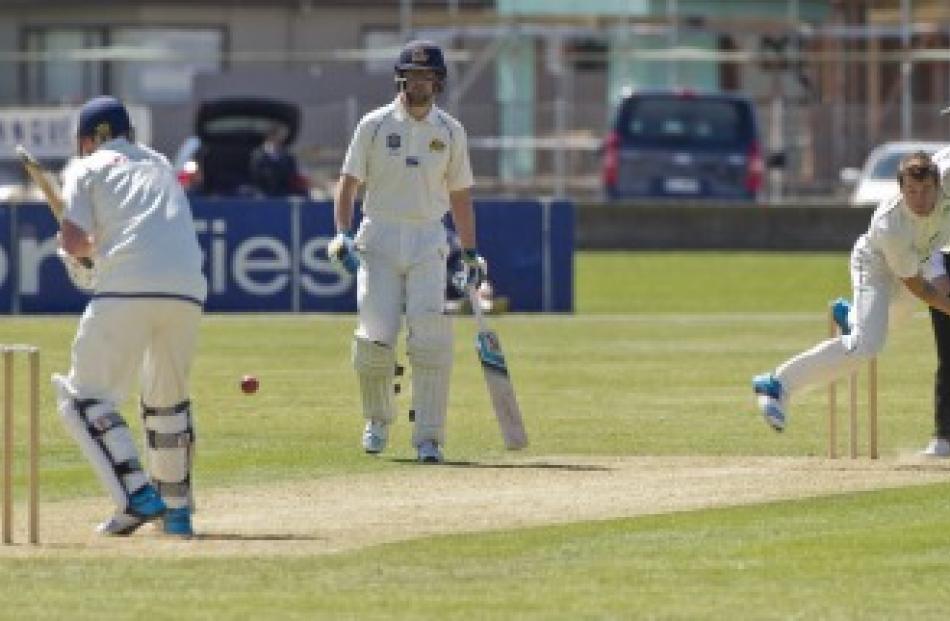 Otago's Mark Craig and Sam Wells face down Central Districts bowler Doug Bracewell at Nelson Park...