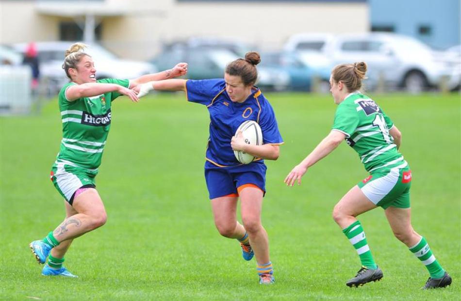 Otago Spirit  wing Michaela Baker fends off Manawatu Cyclones second five-eighth Shanna Porima ...