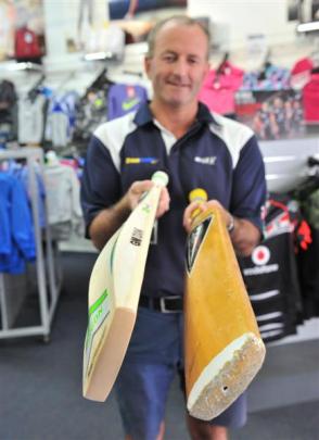 Otago Sports Depot owner Brent Davies compares a modern bat with a Duncan Fearnley bat from the...