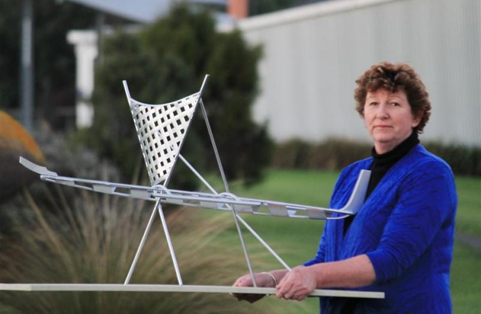 Owaka Going Forward chairwoman Aileen Clarke  displays a model of the waka sculpture being built...