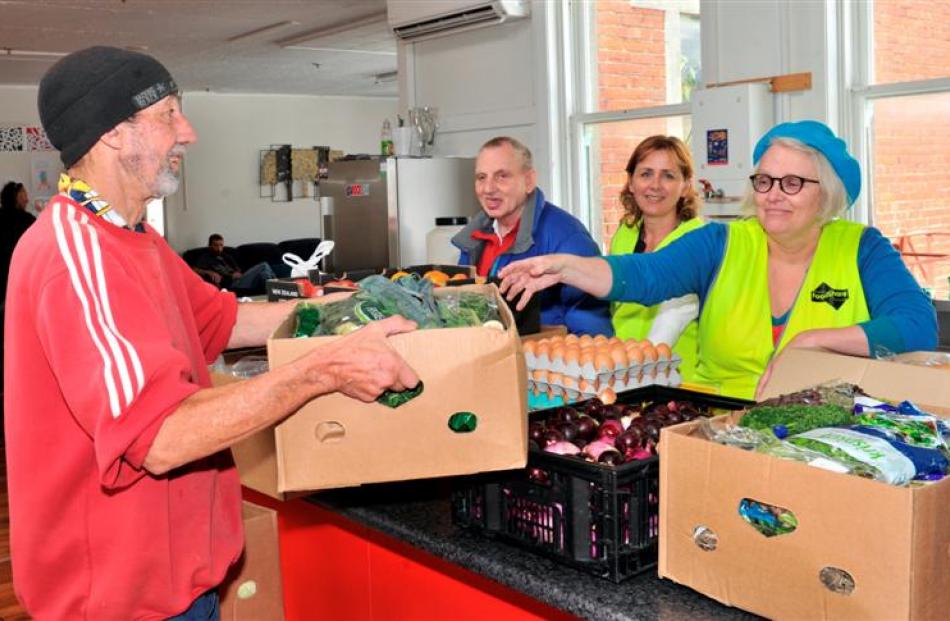 Pact members (from left) Ross Chirnside and Graeme Russell help FoodShare CEO Deborah Manning and...