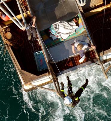 Paramedic Doug Flett is lowered from the Otago Regional Rescue Helicopter yesterday to recover an...