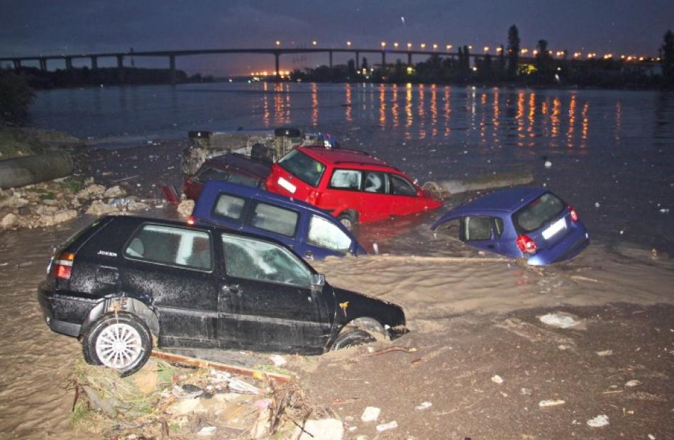 Partially-submerged cars are pictured during heavy flooding in the city of Varna, in northeastern...