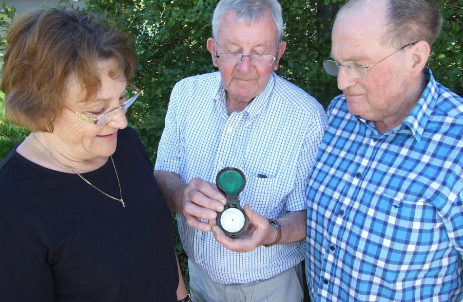 Pat Paulin (centre), of Frankton, shows a barometer to Hugh and Viv Beilby, of Auckland, that was...